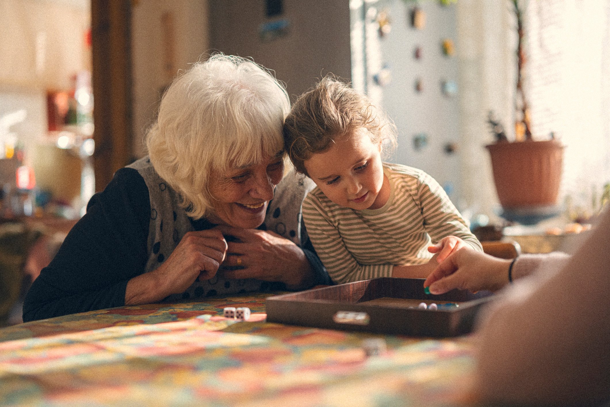 A grandmother and granddaughter playing a game together