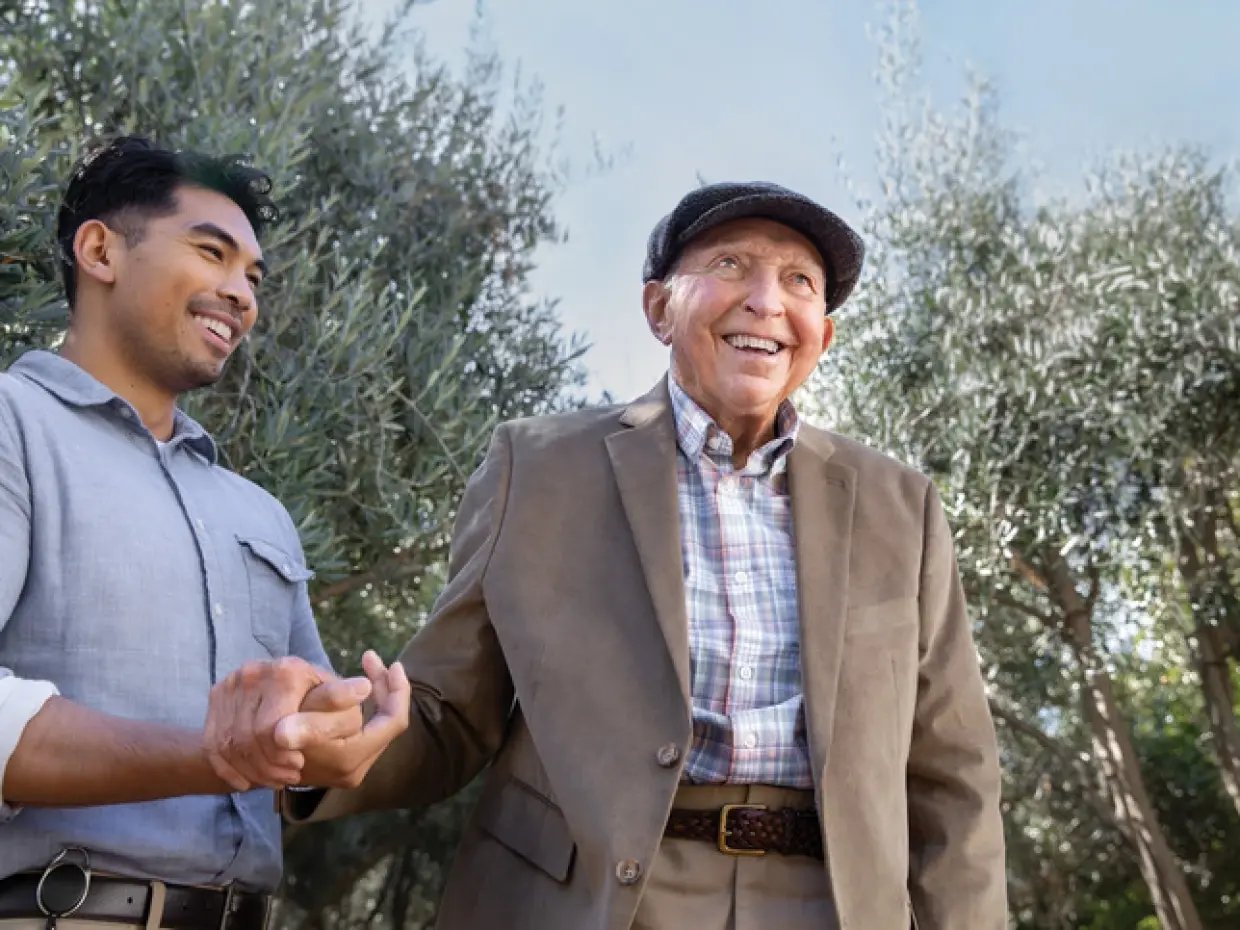 Older gentleman and a caregiver walking together