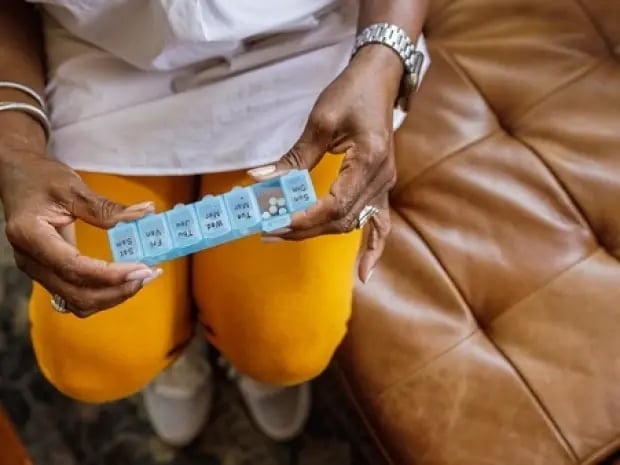 An elderly woman looking at her medication
