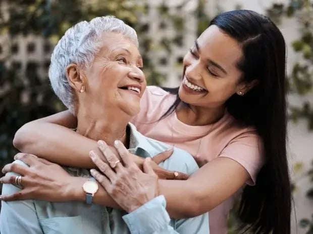 A mother and daughter smiling and laughing